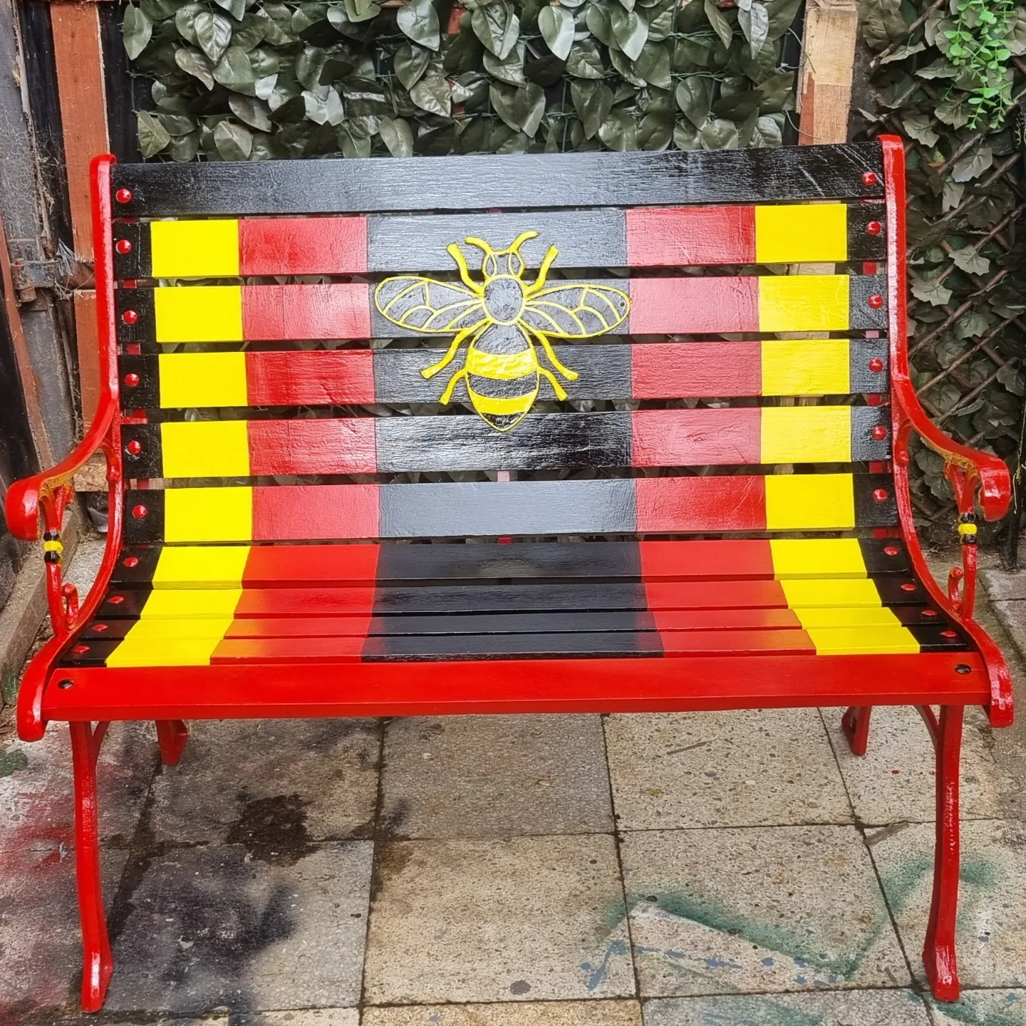Manchester Bee bench — red, yellow and black with hand-painted MCR bee design